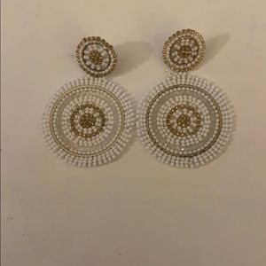 White and gold circle earrings.